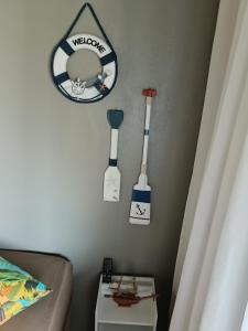a bedroom with three tools hanging on the wall at Verde Mar Abricó 4 in Rio das Ostras