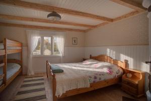 a bedroom with a wooden bed and a window at Sommargyllen Torp Brändabo in Torsås