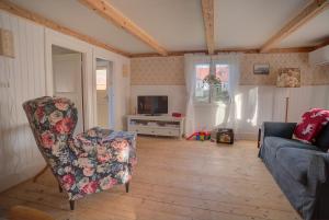 a living room with a couch and a chair at Sommargyllen Torp Brändabo in Torsås