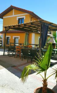 a building with a patio with tables and chairs at Apartamentos Copi Villa de Suances in Suances