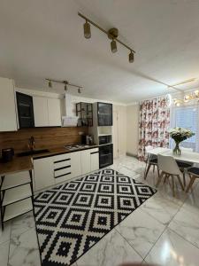 a kitchen with a table and a dining room at Fochyn House in Krivorovnya