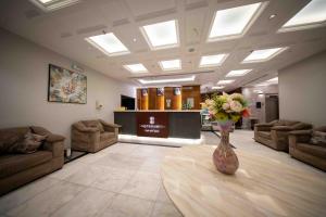 a lobby with a vase of flowers on a table at Afaq Taiba Hotel in Medina