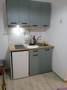 a kitchen with a sink and a stove and cabinets at Smaragdi in Chania +22 photos