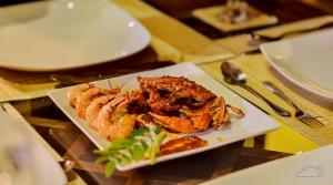 a plate of food with shrimp on a table at Cloud Nine Lanka Resort Wilpattu in Wilpattu +50 photos