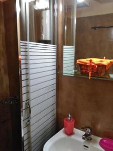 a bathroom with a sink and a mirror with a red candle at Smaragdi in Chania