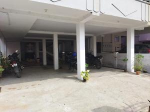 an empty garage with motorcycles parked in it at WooLiv in Coimbatore +8 photos