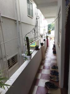 a corridor of a building with a row of plants and shoes at WooLiv in Coimbatore