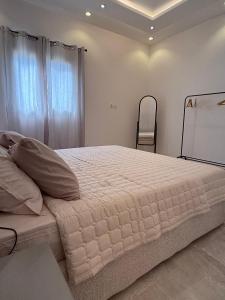 a bedroom with a large bed and a chair at Apartment in Tabuk