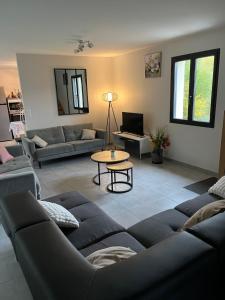 a living room with a couch and a table at GITE DE 6 A 14 PERSONNES Chez Léontine in Lacave