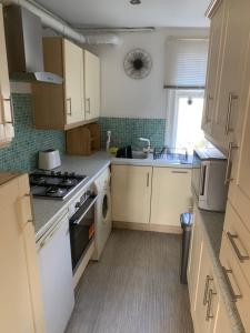 a kitchen with a sink and a stove top oven at Burton Down Town Apartment in Burton upon Trent