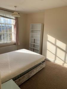 a bedroom with a bed in front of a window at Burton Down Town Apartment in Burton upon Trent
