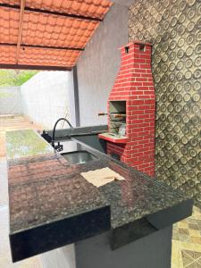 a kitchen with a brick oven on a counter at Casa Paradise in Jijoca de Jericoacoara