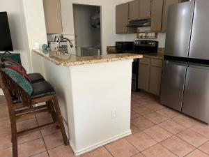 a kitchen with a counter and a refrigerator at The Bobcat in San Marcos