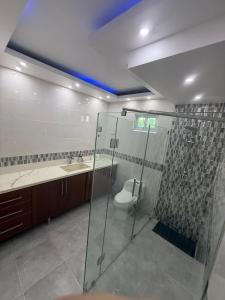 a bathroom with a glass shower and a toilet at Modern Getaway with Private Pool, Montecristi in Villa Vásquez