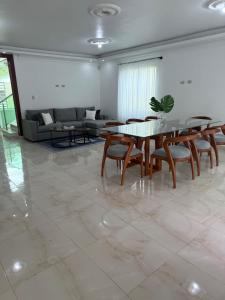 a living room with a table and chairs and a couch at Modern Getaway with Private Pool, Montecristi in Villa Vásquez