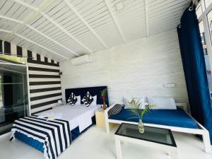 a bedroom with two beds and a table at Feyola`s Leaf in Pelena