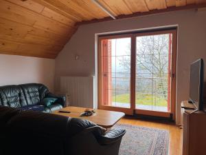 a living room with a couch and a table at Pr Fajfarju in Spodnja Sorica