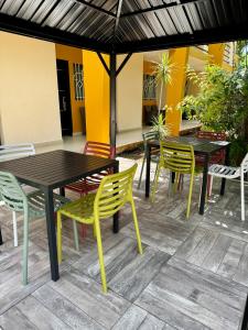 a patio with tables and chairs under an umbrella at Hotel Avila in Valladolid
