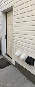 a couple of toilets on the side of a house at Rhote's Luxury Suite in Saskatoon