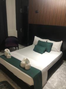 a bedroom with a large bed with towels on it at Hôtel ikrams in Oran