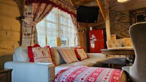 a living room with a couch and a window at Domki góralskie z sauną i jacuzzi in Kościelisko
