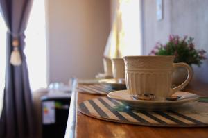 a coffee cup sitting on a table with a saucer at Hospedaje Catriel in Catriel +12 photos