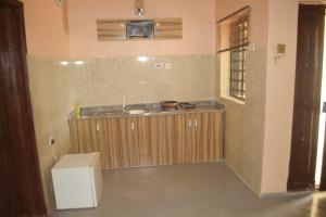 a small kitchen with a sink and a counter at Symphony Chalets 