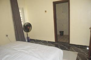 a bedroom with a white bed and a mirror at Symphony Chalets 