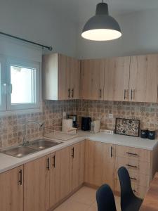 a kitchen with wooden cabinets and a sink at Santa Marina 9 In the center of Ioannina! in Ioannina