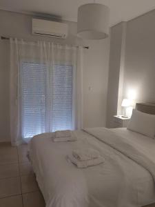 a bedroom with a bed with two towels on it at Santa Marina 9 In the center of Ioannina! in Ioannina