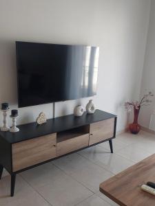 a black entertainment center with a flat screen tv on top at Santa Marina 9 In the center of Ioannina! in Ioannina