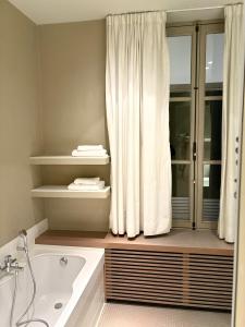 a bathroom with a tub and a shower curtain at Gravenhof in Beersel