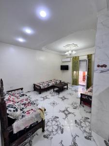 a room with two beds and a table at Filfila skikda in Rebaïb +5 photos