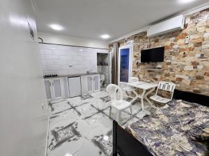 a kitchen with marble floors and a table and chairs at Filfila skikda in Rebaïb
