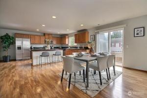 a kitchen and dining room with a table and chairs at Aura in Covington +12 photos