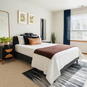 a bedroom with a large bed and a window at Aura in Covington