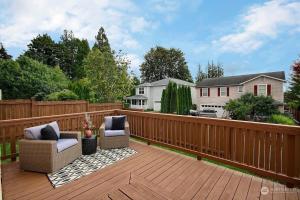 a patio with two chairs on a wooden deck at Aura in Covington