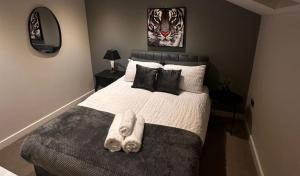 a bedroom with a bed with a towel on it at Stylish Duplex Apartment in Liverpool City Centre in Liverpool