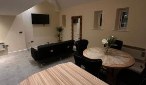 a living room with a table and a television at Stylish Duplex Apartment in Liverpool City Centre in Liverpool