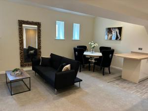 a living room with a couch and a table at Stylish Duplex Apartment in Liverpool City Centre in Liverpool +2 photos
