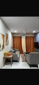 a living room with two couches and a table at Aquaview in Bijilo