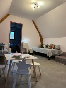 a living room with a couch and a table at GITE DE 6 A 14 PERSONNES Chez Léontine in Lacave