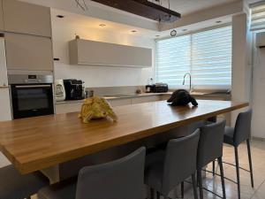a kitchen with a wooden counter with chairs around it at חניתה 40 חיפה in Haifa