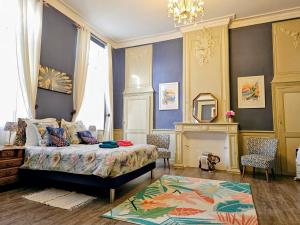 a bedroom with a bed and a fireplace and a mirror at Château Arche d'Aure in Vicq-dʼAuribat