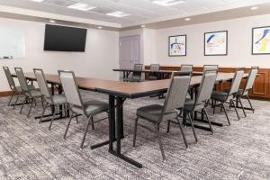 a conference room with a large wooden table and chairs at Staybridge Suites Chandler by IHG in Chandler +63 photos
