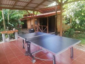 a ping pong table in front of a house at Villas Seashells in Uvita