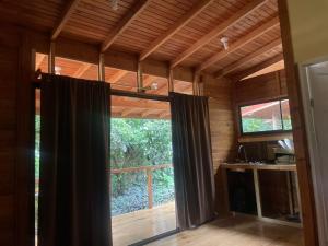 a room with a large window in a house at Villas Seashells in Uvita
