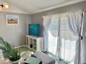 a living room with a tv and a window at Modern Lux 3BR King Bed in Copperas Cove