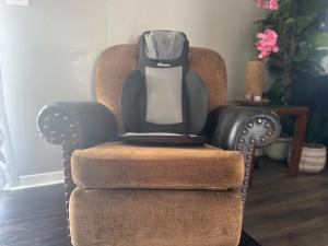 a chair with a backpack on the back of it at Modern Lux 3BR King Bed in Copperas Cove +30 photos