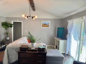 a living room with a bed and a tv at Modern Lux 3BR King Bed in Copperas Cove